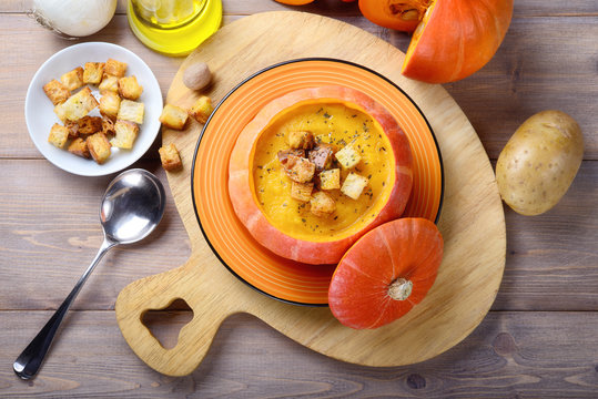 Pumpkin soup with croutons in pumpkin bowl