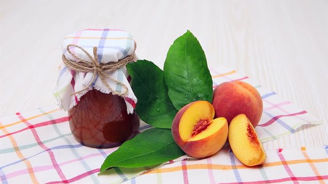 Peach jam in the jar on the table