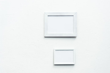 empty photo frames hanging on wall