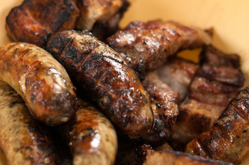 Appetizing fried sausages on a barbecue.