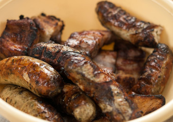 Appetizing fried sausages on a barbecue.