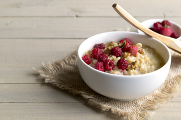 Breakfast with oatmeal and fresh raspberries.