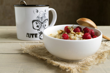 Breakfast with oatmeal and fresh raspberries.