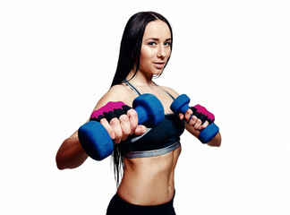 Beautiful young woman do exercises with dumbbells in studio. Sporty athletic girl lifting up weights against white background.