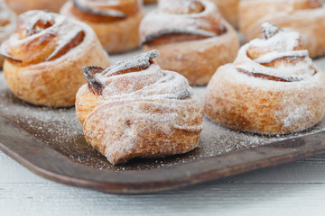 Fresh baked cinnamon rolls on steel baking tray