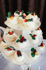 White cookies with berries and ming on wedding candy bar