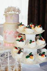 White cookies with berries and ming on wedding candy bar