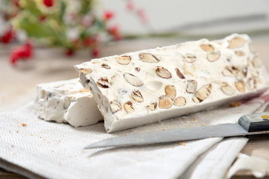 Italian Christmas dessert nugget cut in two pieces on wodden table