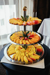 Layered dish with apples, peaches and fruits on a table