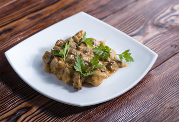 the remains of dinner with chicken and chanterelles with tomato creamy sauce and parsley
