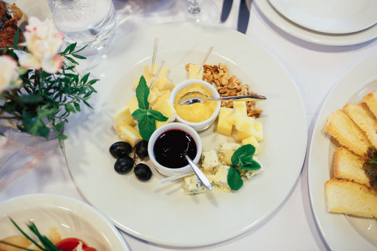 Look from above at cheese and souces on the plate
