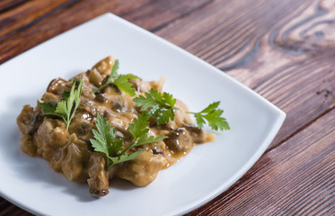 the remains of dinner with chicken and chanterelles with tomato creamy sauce and parsley
