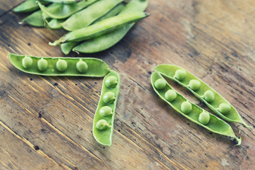 green peas in a wooden table