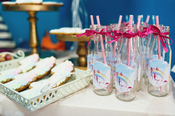 Glass bottles with pink ribbons and unicorns printed on it