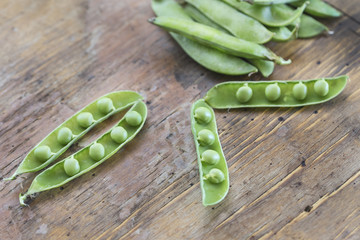 green peas in a wooden table