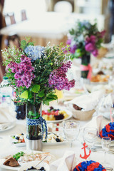 Blue and red serviette with paper anchors served on the dinner plates