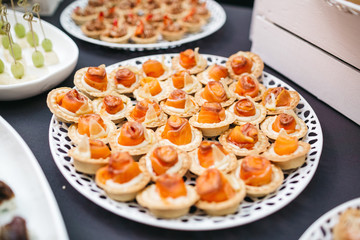 Baked baskets with salty fish served on white plate