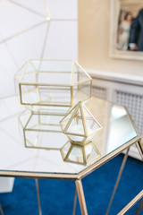 Fototapeta na wymiar Glass boxes stand on a cube on blue carpet