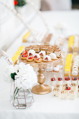Delicious cookies with chocolate and cream served on wooden and golden dishes