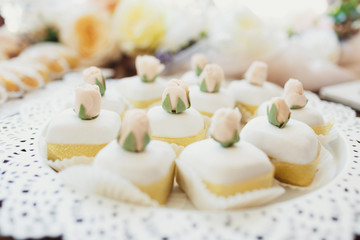 Little white cookies with sweet roses on the top