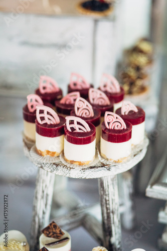Cold Desserts With Berries And White Cream Stand On Wooden