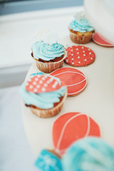 Cupcakes with blue cream and red decor
