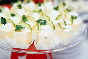 Cheesecakes with lime and mint stand on the glass box