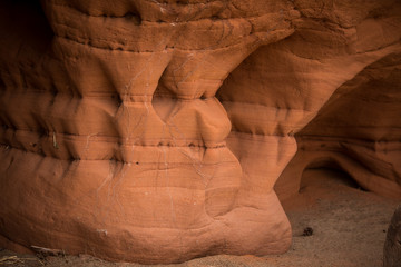 A beautiful closeup of a sandstone cliffs in Latvia. Close pattern of a sand formations. Sandstone caves at the seaside. Colorful photo of sandstone