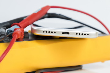 Yellow multimeter and the modern smartphone