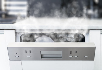 Open dishwasher with steam and clean dishes © leszekglasner