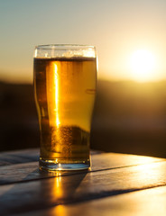 Glass of beer on the sunset.
