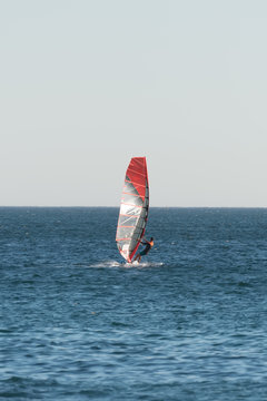 Man windsurfing in the open sea.