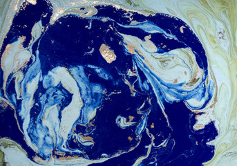Marbled green and blue abstract background with golden sequins. Liquid marble ink pattern.