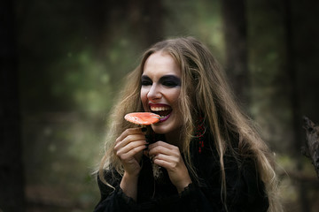 Halloween. beautiful girl witches in the woods with pumpkins