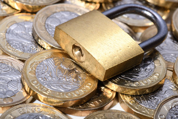 closed padlock on golden coins