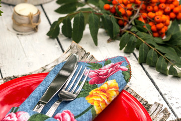 metal fork and knife wrapped in blew napkin close up view