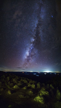 Panorama vertical Milky way galaxy with knob stone ground is name Lan Hin Pum viewpoint at Phu Hin Rong Kla National Park in Phitsanulok, Thailand