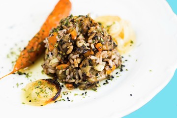 Stewed rice with roasted mushroom, carrot and onion.