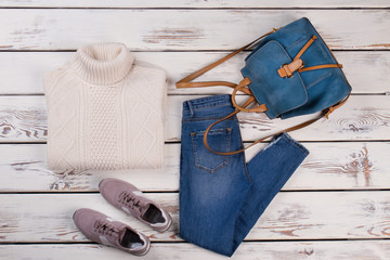 Pullover, jeans, sneakers and backpack