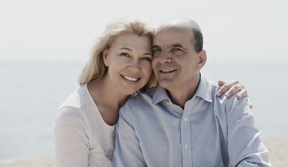 Obraz premium Mature woman and senior at sea beach on vacation smiling