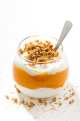 dessert with pumpkin, whipped cream and cookies on white table, vertical