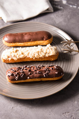 Assortment of eclairs, traditional french dessert. Copy space 