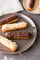 Assortment of eclairs, traditional french dessert. Copy space 