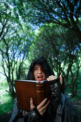 Witch reading spell from book