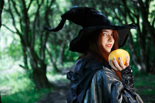 Portrait of witch with pumpkin in hand