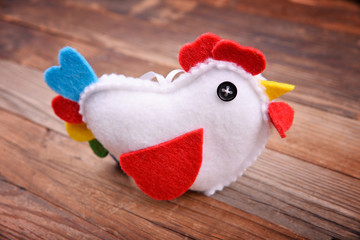 One Cock on wooden brown background