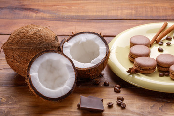Fototapeta na wymiar Coffee, coconut, macaroons, chocolate, cinnamon on wooden background