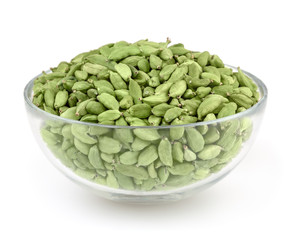 Green cardamon pods in glass bowl isolated on white background