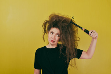 annoyed girl combs her hair