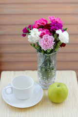 Obraz na płótnie Canvas Flower bouquet, apple and coffee mug